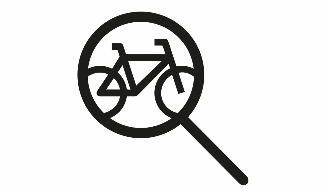 Lupe vergrößert E-Bike, symbolisiert Inspektion und Wartung im E-Bike-Guide.